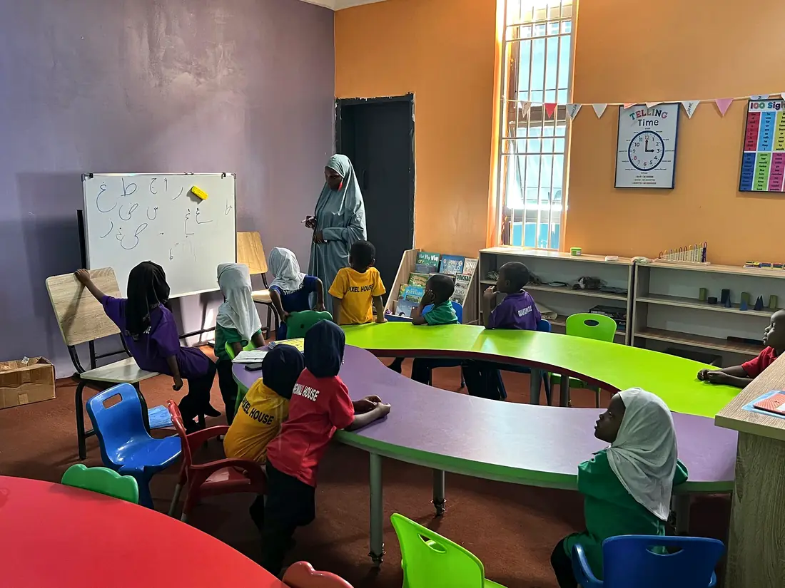 A bright early-years classroom with curved tables
