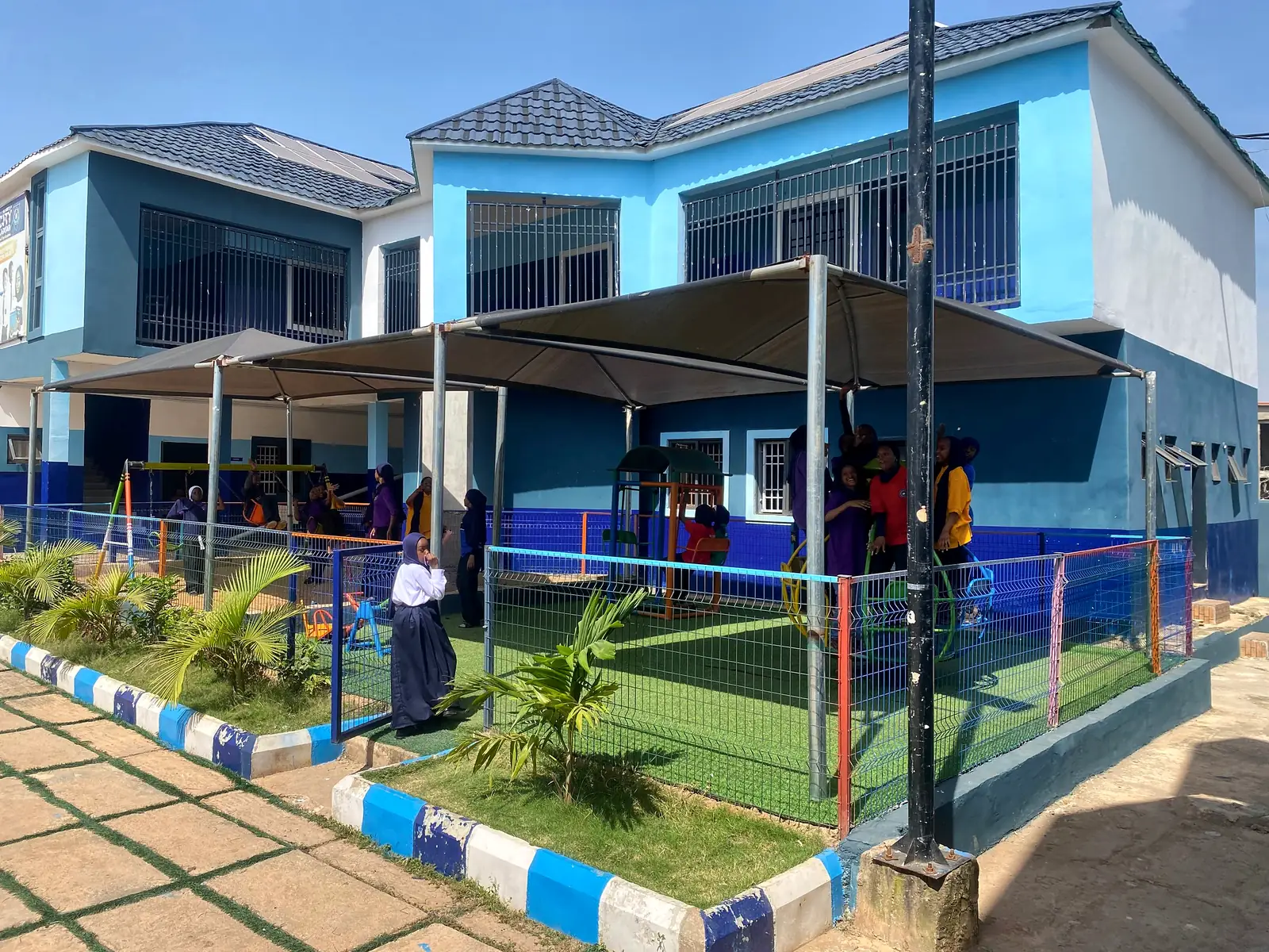 The shaded early-years playground beside the classroom block