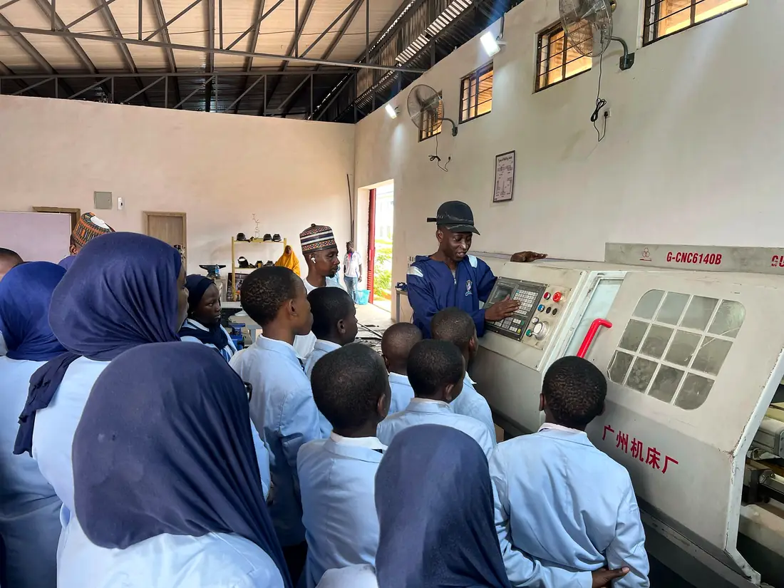 Pupils watching a CNC lathe demonstration