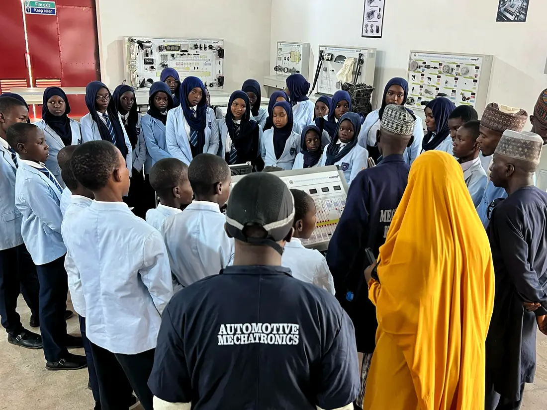 Pupils gathered in an automotive mechatronics workshop